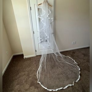 Cathedral length wedding veil; white tulle with satin edging